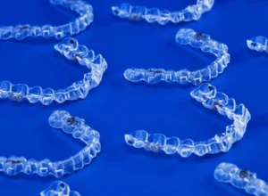 several clear aligner trays in a flat surface several clear aligner trays in a flat surface