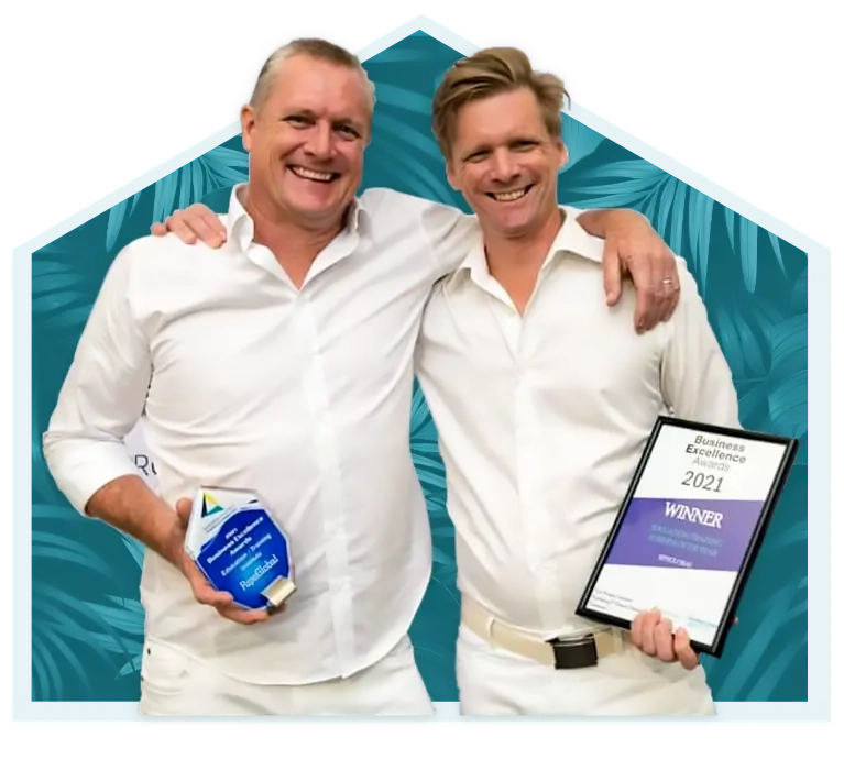 Dr Lincoln with another person holding business award trophies and certificates